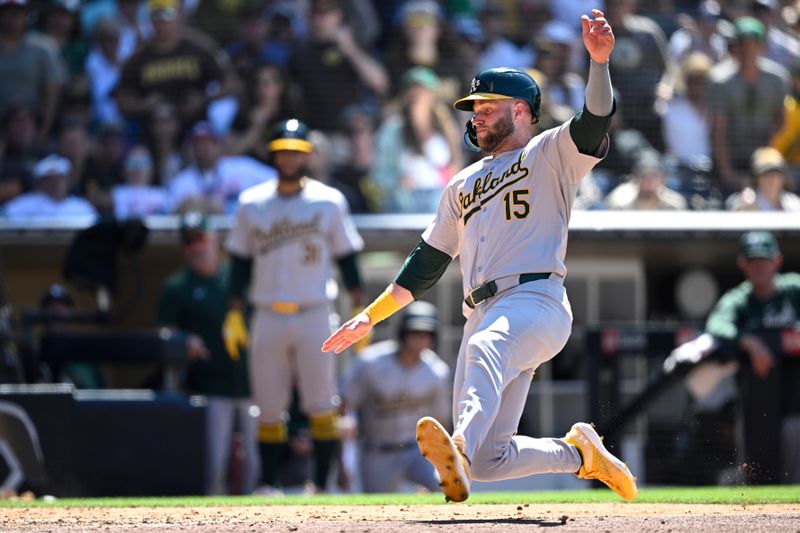 Jun 12, 2024; San Diego, California, USA; Oakland Athletics right fielder Seth Brown (15) slides home to score a run against the San Diego Padres during the eighth inning at Petco Park. Mandatory Credit: Orlando Ramirez-USA TODAY Sports