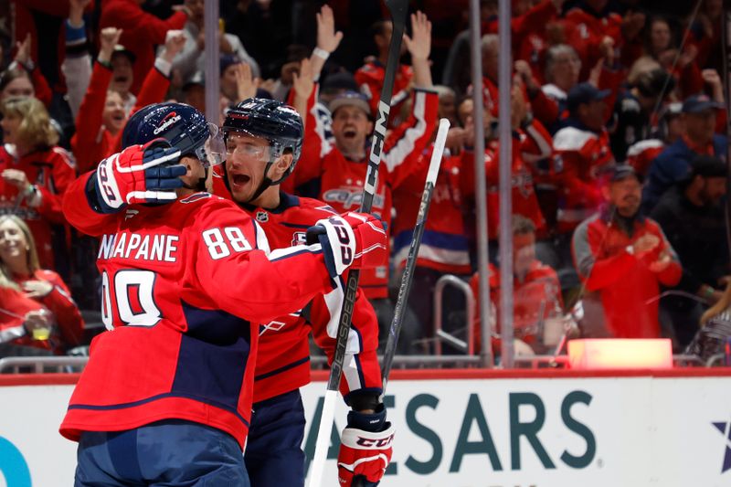 Oct 15, 2024; Washington, District of Columbia, USA; Washington Capitals left wing Jakub Vrana (13) celebrates with Capitals left wing Andrew Mangiapane (88) after scoring a goal against the Vegas Golden Knights in the first period at Capital One Arena. Mandatory Credit: Geoff Burke-Imagn Images