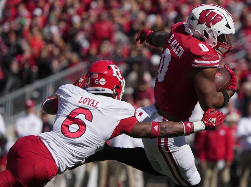 Oct 7, 2023; Madison, Wisconsin, USA; Wisconsin running back Braelon Allen (0) breaks a tackle by Rutgers defensive back Shaquan Loyal (6) enroute to a touchdown run during the second quarter at Camp Randall Stadium. Mandatory Credit: Mark Hoffman-USA TODAY Sports