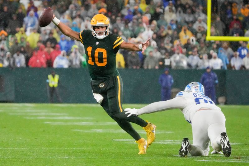 Green Bay Packers quarterback Jordan Love (10) runs around Detroit Lions defensive end Pat O'Connor (95) during the second half of an NFL football game Sunday, Nov. 3, 2024, in Green Bay, Wis. (AP Photo/Morry Gash)