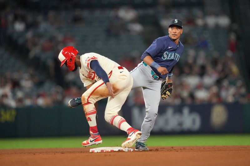 Jul 12, 2024; Anaheim, California, USA; Seattle Mariners second baseman Jorge Polanco (7) forces out Los Angeles Angels right fielder Jo Adell (7) out at second base in the ninth inning at Angel Stadium. Mandatory Credit: Kirby Lee-USA TODAY Sports