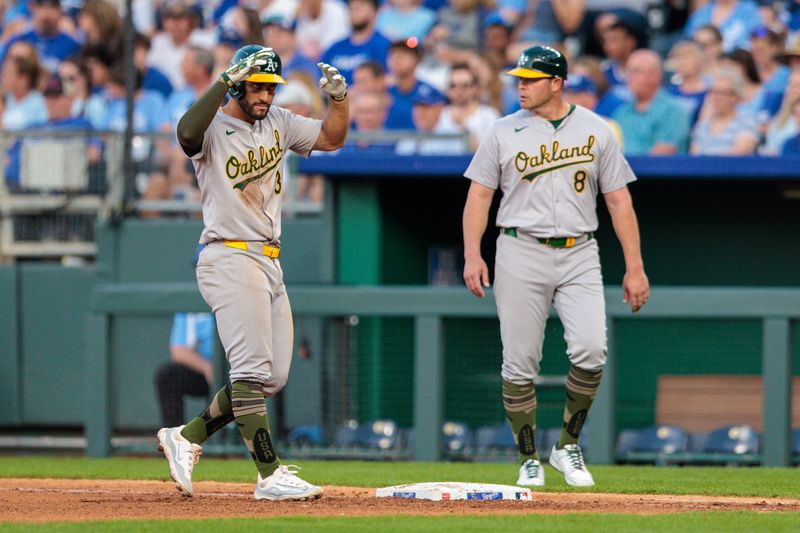 May 18, 2024; Kansas City, Missouri, USA; Oakland Athletics third base coach Eric Martins (3) motions to the dugout after hitting a single during the seventh inning against the Kansas City Royals at Kauffman Stadium. Mandatory Credit: William Purnell-USA TODAY Sports
