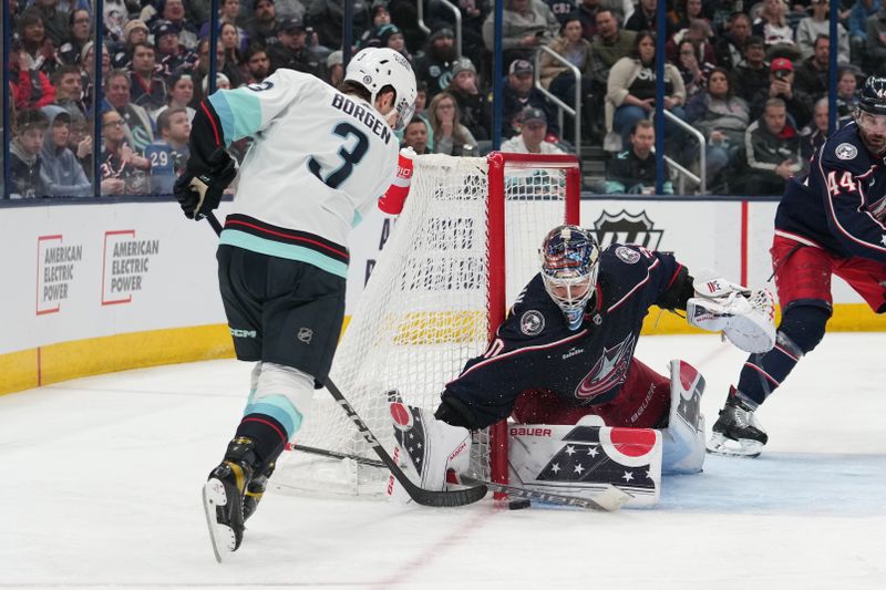 Mar 3, 2023; Columbus, Ohio, USA; Columbus Blue Jackets goaltender Elvis Merzlikins (90) blocks a shot by Seattle Kraken defenseman Will Borgen (3) during the third period at Nationwide Arena. Mandatory Credit: Jason Mowry-USA TODAY Sports