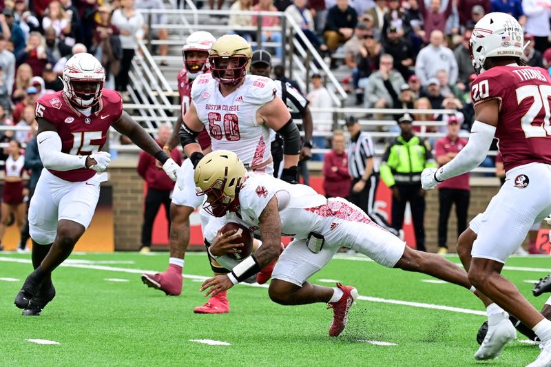 Sep 16, 2023; Chestnut Hill, Massachusetts, USA; Boston College Eagles quarterback Thomas Castellanos (1) runs the ball with Florida State Seminoles linebacker Tatum Bethune (15) closing in during the first half at Alumni Stadium. Mandatory Credit: Eric Canha-USA TODAY Sports