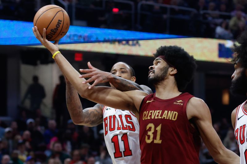 CLEVELAND, OH - FEBRUARY 14: Jarrett Allen #31 of the Cleveland Cavaliers rebounds against DeMar DeRozan #11 of the Chicago Bulls during the first half at Rocket Mortgage Fieldhouse on February 14, 2024 in Cleveland, Ohio. NOTE TO USER: User expressly acknowledges and agrees that, by downloading and or using this photograph, User is consenting to the terms and conditions of the Getty Images License Agreement. (Photo by Ron Schwane/Getty Images)