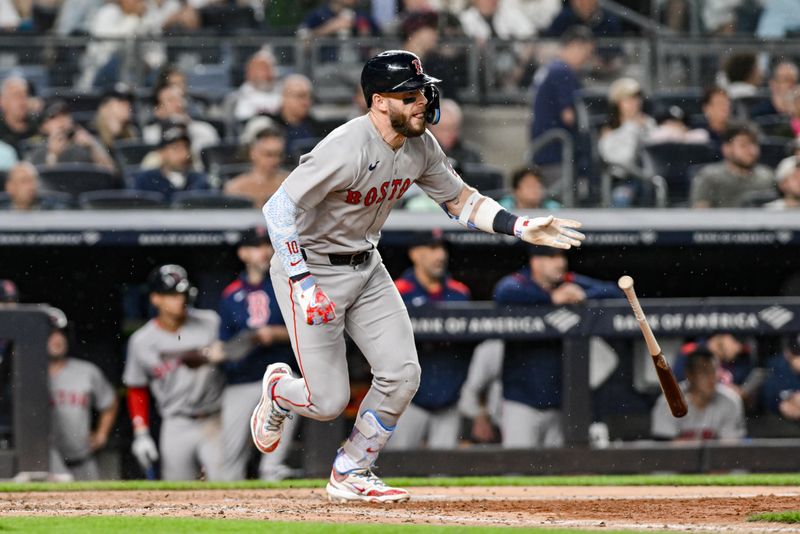 Jun 8, 2025; Bronx, New York, USA; Boston Red Sox shortstop Trevor Story (10) hits a single against the New York Yankees during the sixth inning at Yankee Stadium. Mandatory Credit: John Jones-Imagn Images