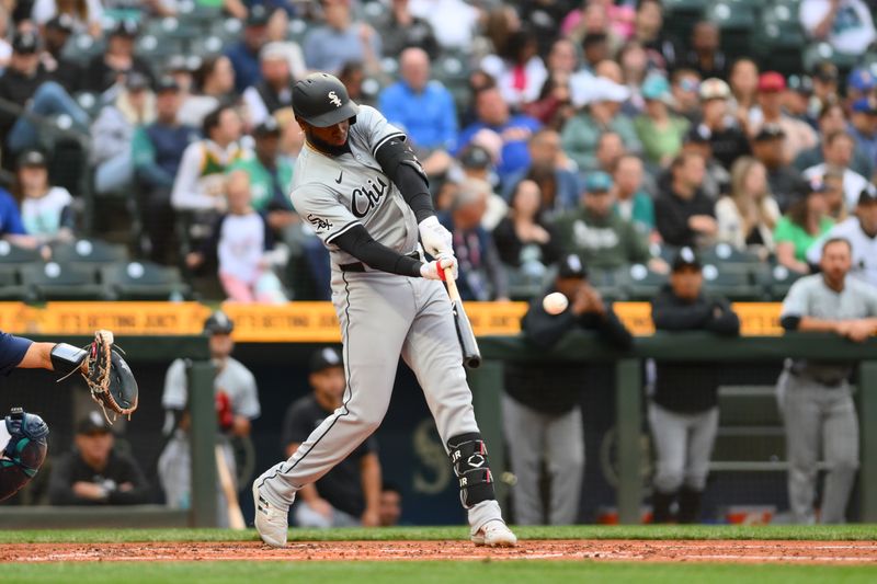 Jun 13, 2024; Seattle, Washington, USA; Chicago White Sox center fielder Luis Robert Jr. (88) hits a home run against the Seattle Mariners during the third inning at T-Mobile Park. Mandatory Credit: Steven Bisig-USA TODAY Sports