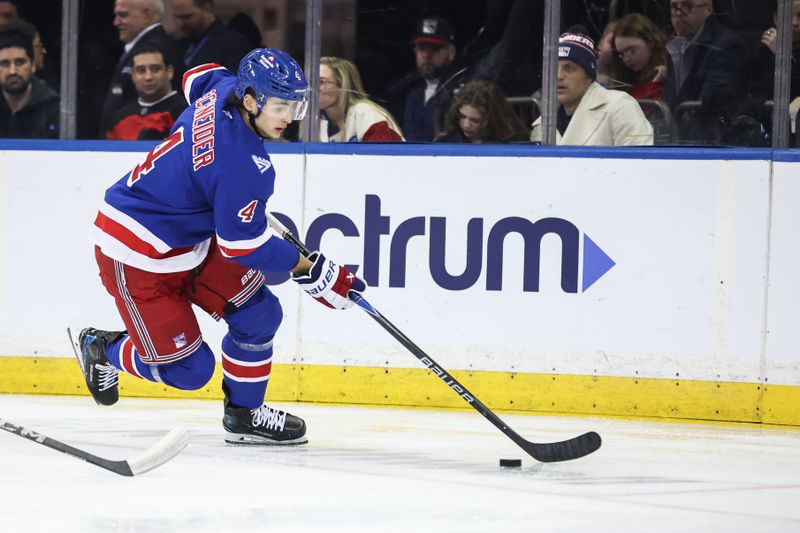 Mar 18, 2026; New York, New York, USA;  New York Rangers defenseman Braden Schneider (4) controls the puck in the second period against the New Jersey Devils at Madison Square Garden. Mandatory Credit: Wendell Cruz-Imagn Images