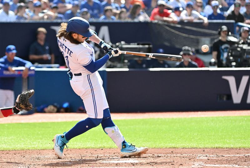 May 13, 2023; Toronto, Ontario, CAN; Toronto Blue Jays shortstop Bo Bichette (11) hits an RBI single against the Atlanta Braves in the fifth inning at Rogers Centre. Mandatory Credit: Dan Hamilton-USA TODAY Sports