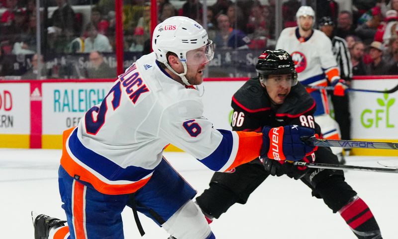 Apr 30, 2024; Raleigh, North Carolina, USA; New York Islanders defenseman Ryan Pulock (6) takes a shot against the Carolina Hurricanes during the second period in game five of the first round of the 2024 Stanley Cup Playoffs at PNC Arena. Mandatory Credit: James Guillory-USA TODAY Sports