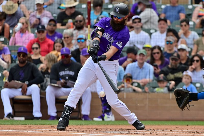 Mar 12, 2024; Salt River Pima-Maricopa, Arizona, USA;   Colorado Rockies designated hitter Charlie Blackmon (19) singles in the first inning against the Kansas City Royals during a spring training game at Salt River Fields at Talking Stick. Mandatory Credit: Matt Kartozian-USA TODAY Sports