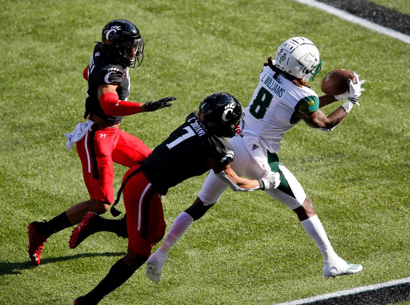 Oct 3, 2020; Cincinnati, OH, USA; South Florida Bulls wide receiver Latrell Williams (8) makes the catch over Cincinnati Bearcats cornerback Coby Bryant (7)during the first quarter at Nippert Stadium. Mandatory Credit: Joseph Maiorana-USA TODAY Sports