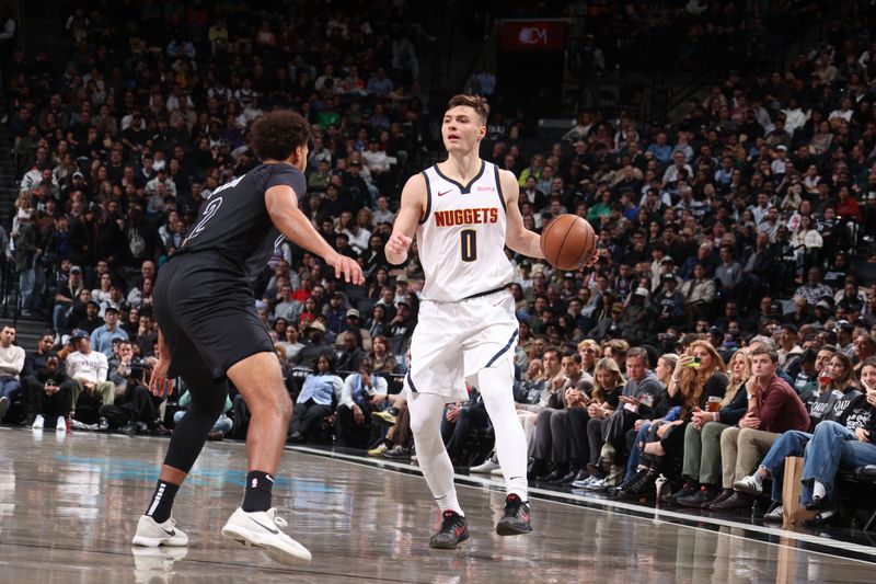 BROOKLYN, NY - OCTOBER 29: Christian Braun #0 of the Denver Nuggets handles the ball during the game against the Brooklyn Nets on October 29, 2024 at Barclays Center in Brooklyn, New York. NOTE TO USER: User expressly acknowledges and agrees that, by downloading and or using this Photograph, user is consenting to the terms and conditions of the Getty Images License Agreement. Mandatory Copyright Notice: Copyright 2024 NBAE (Photo by Nathaniel S. Butler/NBAE via Getty Images)