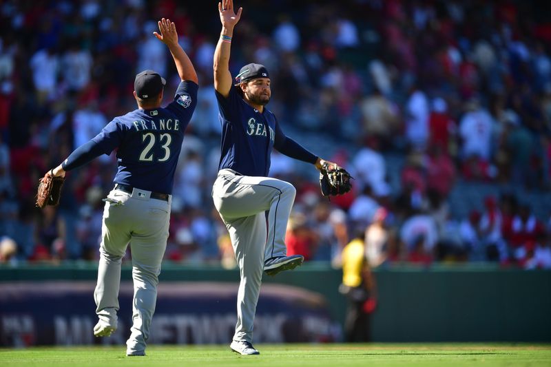 Aug 6, 2023; Anaheim, California, USA; Seattle Mariners first baseman Ty France (23) and Seattle Mariners third baseman Eugenio Suarez (28) celebrate the victory against the Los Angeles Angels at Angel Stadium. Mandatory Credit: Gary A. Vasquez-USA TODAY Sports