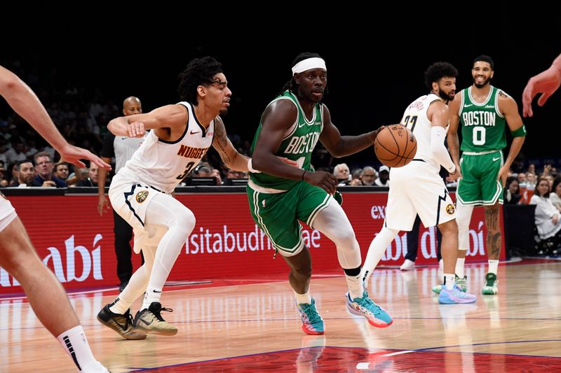 ABU DHABI, UAE - OCTOBER 6: Jrue Holiday #4 of the Boston Celtics drives to the basket during the game against the Denver Nuggets during the 2024 Global Games on October 6, 2024 at the Etihad Arena in Abu Dhabi, United Arab Emirates. NOTE TO USER: User expressly acknowledges and agrees that, by downloading and/or using this Photograph, user is consenting to the terms and conditions of the Getty Images License Agreement. Mandatory Copyright Notice: Copyright 2024 NBAE (Photo by Brian Babineau/NBAE via Getty Images)