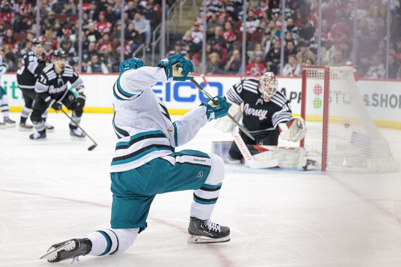 Dec 1, 2023; Newark, New Jersey, USA; San Jose Sharks left wing Anthony Duclair (10) scores a goal past New Jersey Devils goaltender Akira Schmid (40) during the second period at Prudential Center. Mandatory Credit: Vincent Carchietta-USA TODAY Sports