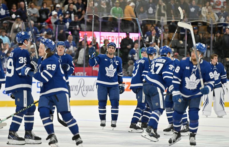 Oct 14, 2023; Toronto, Ontario, CAN;   Toronto Maple Leafs players salute their fans after a win over the Minnesota Wild at Scotiabank Arena. Mandatory Credit: Dan Hamilton-USA TODAY Sports