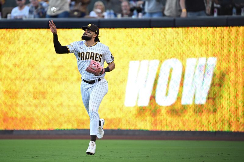 Jun 15, 2023; San Diego, California, USA; San Diego Padres right fielder Fernando Tatis Jr. (23) tosses the ball after making a catch during the fourth inning against the Cleveland Guardians at Petco Park. Mandatory Credit: Orlando Ramirez-USA TODAY Sports