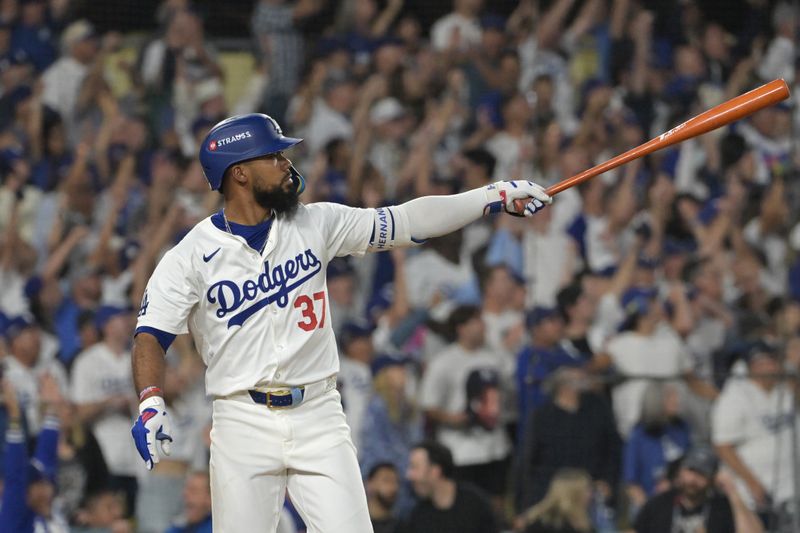 Oct 11, 2024; Los Angeles, California, USA; Los Angeles Dodgers outfielder Teoscar Hernandez (37) hits a solo home run in the seventh inning against the San Diego Padres during game five of the NLDS for the 2024 MLB Playoffs at Dodger Stadium. Mandatory Credit: Jayne Kamin-Oncea-Imagn Images