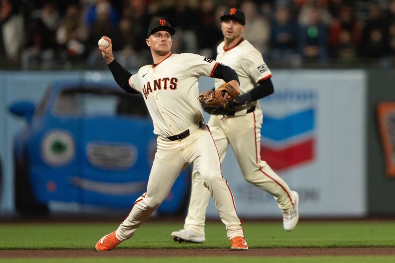 Apr 18, 2024; San Francisco, California, USA;  San Francisco Giants third base Matt Chapman (26) throws the ball during the seventh inning against the Arizona Diamondbacks at Oracle Park. Mandatory Credit: Stan Szeto-USA TODAY Sports