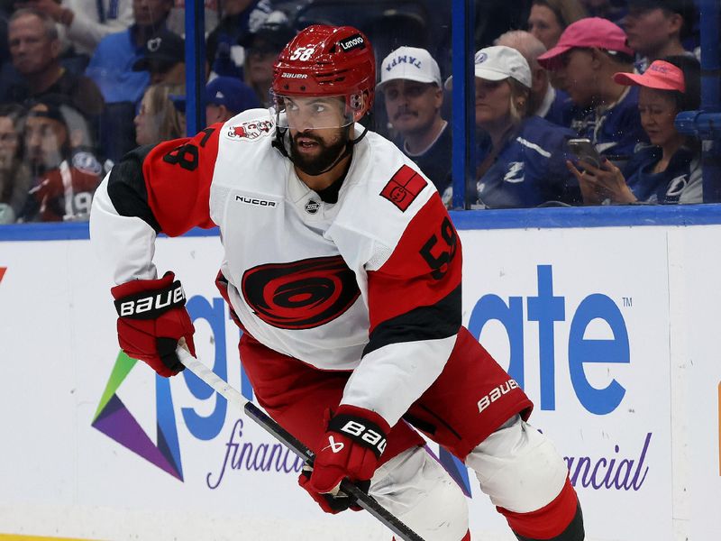Sep 26, 2025; Tampa, Florida, USA; Carolina Hurricanes 
Oliver Kylington (58) skates against the Tampa Bay Lightning during the third period at Benchmark International Arena. Mandatory Credit: Kim Klement Neitzel-Imagn Images