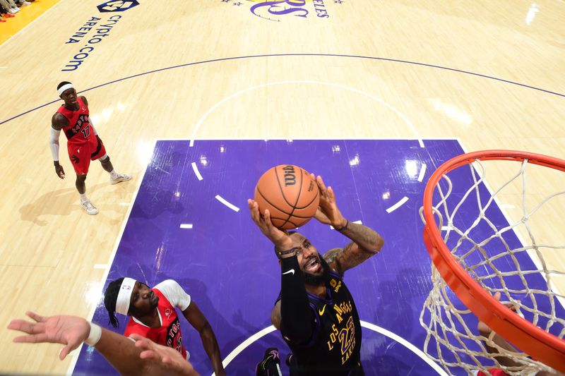 LOS ANGELES, CA - JANUARY 9: LeBron James #23 of the Los Angeles Lakers drives to the basket during the game against the Toronto Raptors on January 9, 2024 at Crypto.Com Arena in Los Angeles, California. NOTE TO USER: User expressly acknowledges and agrees that, by downloading and/or using this Photograph, user is consenting to the terms and conditions of the Getty Images License Agreement. Mandatory Copyright Notice: Copyright 2024 NBAE (Photo by Adam Pantozzi/NBAE via Getty Images)