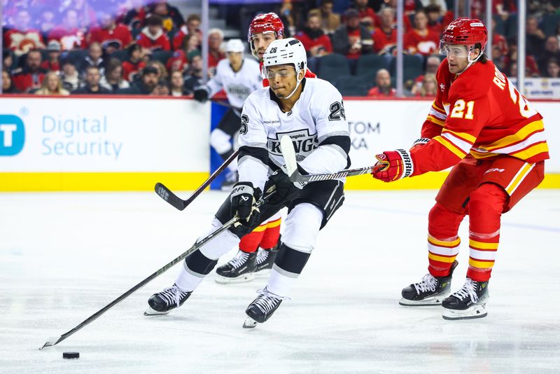 Nov 11, 2024; Calgary, Alberta, CAN; Los Angeles Kings center Akil Thomas (26) and Calgary Flames center Kevin Rooney (21) battles for the puck during the first period at Scotiabank Saddledome. Mandatory Credit: Sergei Belski-Imagn Images