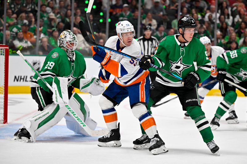 Oct 12, 2024; Dallas, Texas, USA; New York Islanders center Casey Cizikas (53) and Dallas Stars defenseman Nils Lundkvist (5) and goaltender Jake Oettinger (29) look for the puck in the Stars zone during the third period at the American Airlines Center. Mandatory Credit: Jerome Miron-Imagn Images