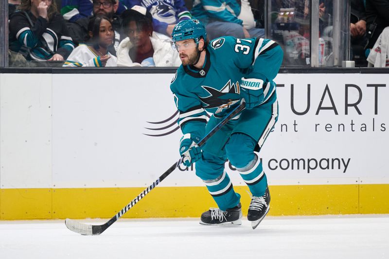 Nov 2, 2024; San Jose, California, USA; San Jose Sharks defenseman Timothy Liljegren (37) plays the puck against the Vancouver Canucks during the second period at SAP Center at San Jose. Mandatory Credit: Robert Edwards-Imagn Images