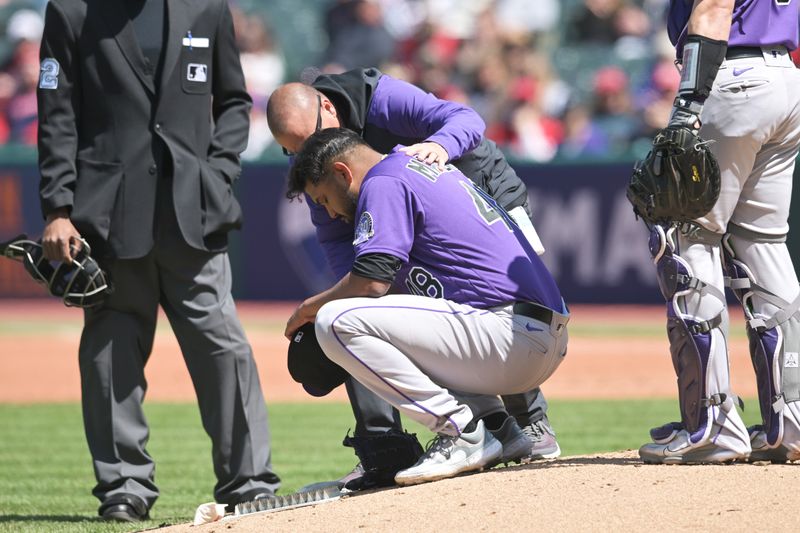 Apr 26, 2023; Cleveland, Ohio, USA; Colorado Rockies starting pitcher German Marquez (48) is looked at by a trainer on the mound before leaving the game during the fourth inning against the Cleveland Guardians at Progressive Field. Mandatory Credit: Ken Blaze-USA TODAY Sports