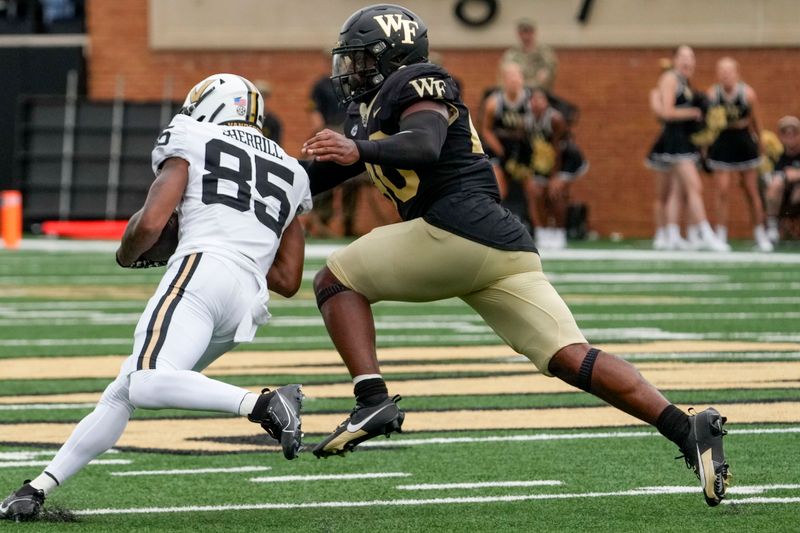 Sep 9, 2023; Winston-Salem, North Carolina, USA; Wake Forest Demon Deacons defensive back DaShawn Jones (10) chases Vanderbilt Commodores wide receiver Junior Sherrill (85) during the second half at Allegacy Federal Credit Union Stadium. Mandatory Credit: Jim Dedmon-USA TODAY Sports