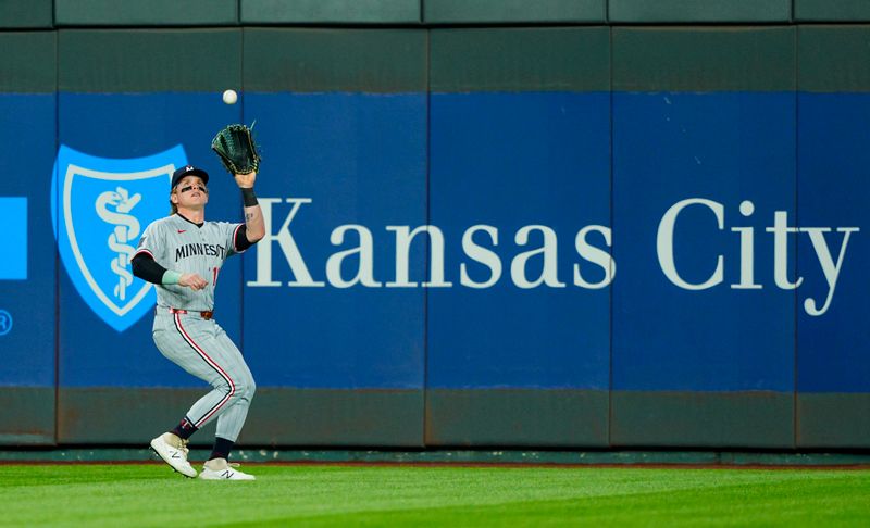 Apr 9, 2025; Kansas City, Missouri, USA; Minnesota Twins center fielder Harrison Bader (12) catches a fly ball during the sixth inning against the Kansas City Royals at Kauffman Stadium. Mandatory Credit: Jay Biggerstaff-Imagn Images