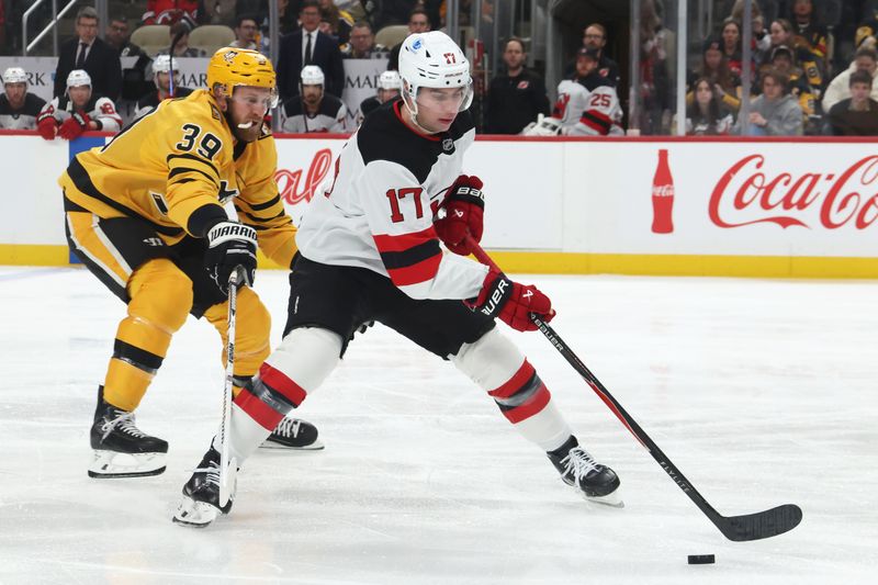 Jan 8, 2026; Pittsburgh, Pennsylvania, USA;  New Jersey Devils defenseman Simon Nemec (17) moves the puck against pressure from Pittsburgh Penguins right wing Anthony Mantha (39) during the first period at PPG Paints Arena. Mandatory Credit: Charles LeClaire-Imagn Images