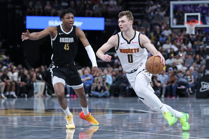 MEMPHIS, TENNESSEE - APRIL 14: Christian Braun #0 of the Denver Nuggets drives to the basket during the first half against GG Jackson #45 of the Memphis Grizzlies at FedExForum on April 14, 2024 in Memphis, Tennessee. NOTE TO USER: User expressly acknowledges and agrees that, by downloading and or using this photograph, User is consenting to the terms and conditions of the Getty Images License Agreement. (Photo by Justin Ford/Getty Images)