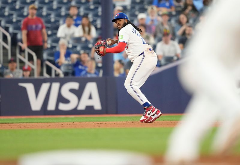 Jun 4, 2024; Toronto, Ontario, CAN; Toronto Blue Jays third baseman Vladimir Guerrero Jr. (27) throws out Baltimore Orioles first baseman Ryan Mountcastle (not pictured) at first base during the ninth inning at Rogers Centre. Mandatory Credit: John E. Sokolowski-USA TODAY Sports