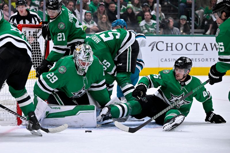 Nov 20, 2024; Dallas, Texas, USA; Dallas Stars goaltender Jake Oettinger (29) and left wing Jason Robertson (21) and defenseman Thomas Harley (55) and defenseman Ilya Lyubushkin (46) keep the puck out of the net on the San Jose Sharks attack during the third period at the American Airlines Center. Mandatory Credit: Jerome Miron-Imagn Images