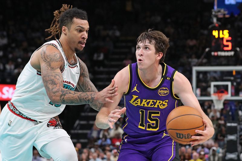 MEMPHIS, TENNESSEE - NOVEMBER 06: Austin Reaves #15 of the Los Angeles Lakers handles the ball against Brandon Clarke #15 of the Memphis Grizzlies during the first half at FedExForum on November 06, 2024 in Memphis, Tennessee. NOTE TO USER: User expressly acknowledges and agrees that, by downloading and or using this photograph, User is consenting to the terms and conditions of the Getty Images License Agreement. (Photo by Justin Ford/Getty Images)