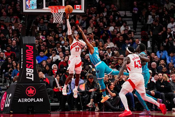 TORONTO, ON - DECEMBER 18: Dennis Schroder #17 of the Toronto Raptors goes to the basket against Ish Smith #14 of the Charlotte Hornets during second half NBA action at Scotiabank Arena on December 18, 2023 in Toronto, Ontario, Canada. NOTE TO USER: User expressly acknowledges and agrees that, by downloading and/or using this Photograph, user is consenting to the terms and conditions of the Getty Images License Agreement. (Photo by Andrew Lahodynskyj/Getty Images)