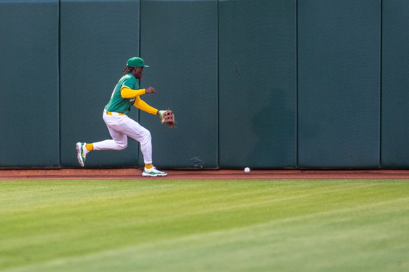 Sep 24, 2024; Oakland, California, USA; Oakland Athletics right fielder Lawrence Butler (4) chase down a fly ball against the Texas Rangers during the first inning at Oakland-Alameda County Coliseum. Mandatory Credit: Neville E. Guard-Imagn Images