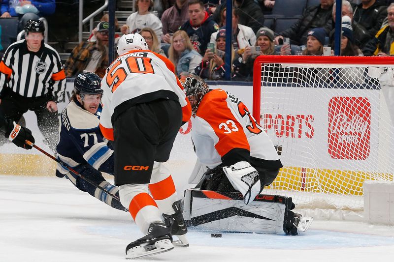 Apr 6, 2024; Columbus, Ohio, USA; Philadelphia Flyers goalie Samuel Ersson (33) makes a pad save on the shot from Columbus Blue Jackets defenseman Nick Blankenburg (77) during the first period at Nationwide Arena. Mandatory Credit: Russell LaBounty-USA TODAY Sports