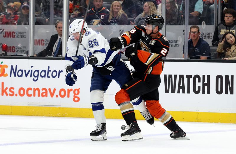 Mar 24, 2024; Anaheim, California, USA; Tampa Bay Lightning right wing Nikita Kucherov (86) and Anaheim Ducks defenseman Gustav Lindstrom (28) fight for the puck during the first period at Honda Center. Mandatory Credit: Jason Parkhurst-USA TODAY Sports