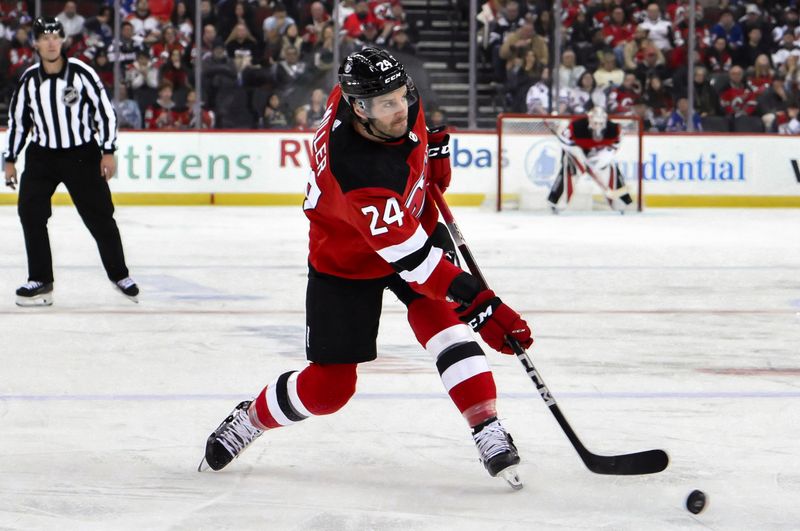 Nov 18, 2023; Newark, New Jersey, USA; New Jersey Devils defenseman Colin Miller (24) shoots the puck during the second period against the New York Rangers at Prudential Center. Mandatory Credit: John Jones-USA TODAY Sports