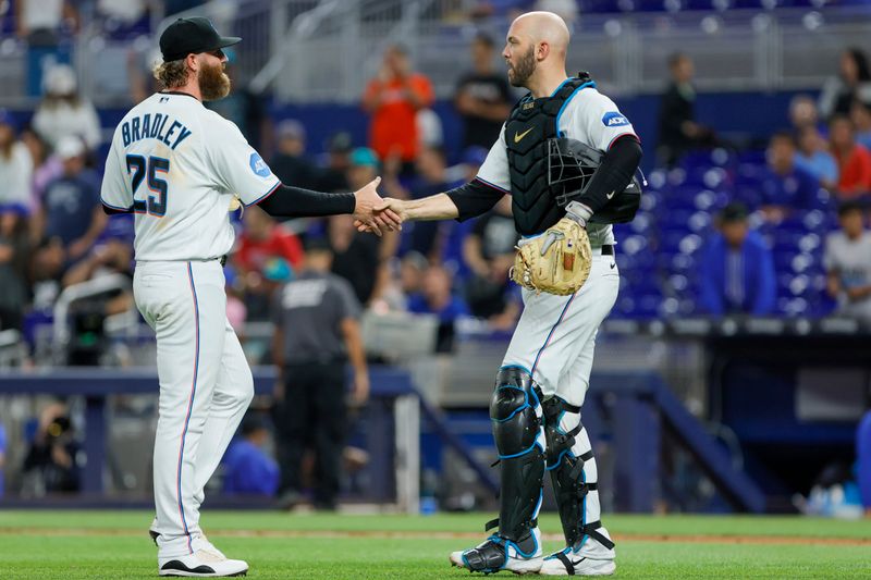 Jun 19, 2023; Miami, Florida, USA; Miami Marlins relief pitcher Archie Bradley (25) celebrates with catcher Jacob Stallings (58) after winning the game against the Toronto Blue Jays at loanDepot Park. Mandatory Credit: Sam Navarro-USA TODAY Sports