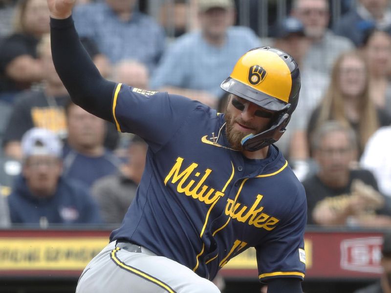 Sep 26, 2024; Pittsburgh, Pennsylvania, USA;  Milwaukee Brewers catcher Eric Haase (13) slides across home plate to score a run against the Pittsburgh Pirates as the ball kicks away during the fifth inning at PNC Park. Mandatory Credit: Charles LeClaire-Imagn Images