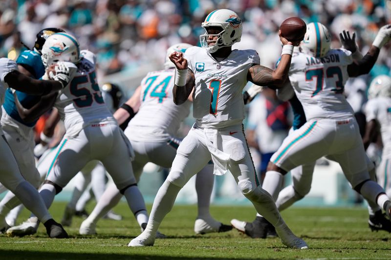 Miami Dolphins quarterback Tua Tagovailoa (1) aims a pass during the second half of an NFL football game against the Jacksonville Jaguars, Sunday, Sept. 8, 2024, in Miami Gardens, Fla. (AP Photo/Rebecca Blackwell)