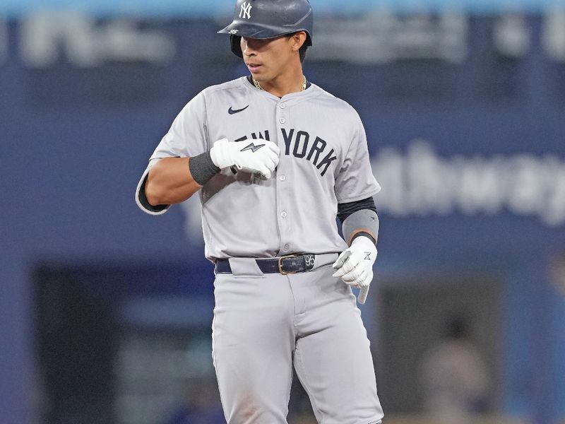 Apr 17, 2024; Toronto, Ontario, CAN; New York Yankees third base Oswaldo Cabrera (95) celebrates hitting a double against the Toronto Blue Jays during the fifth inning at Rogers Centre. Mandatory Credit: Nick Turchiaro-USA TODAY Sports