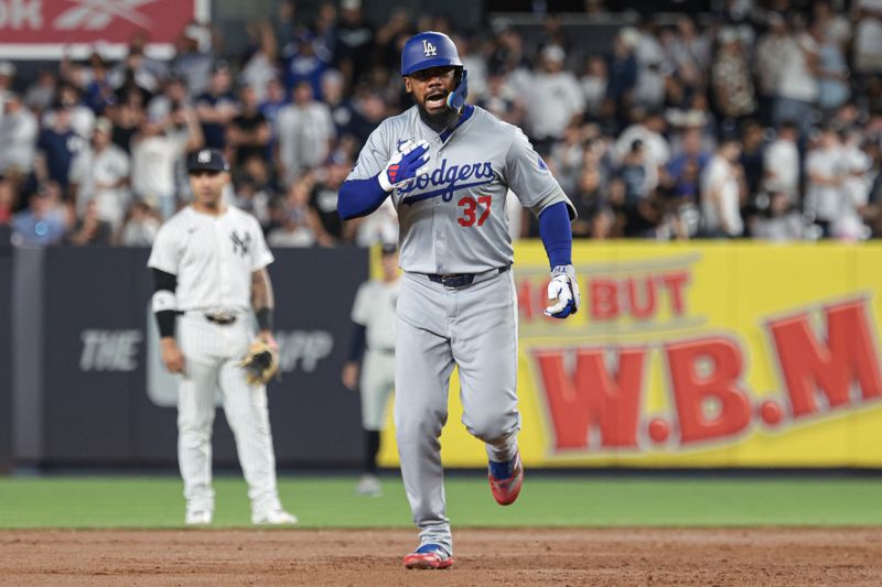 Jun 8, 2024; Bronx, New York, USA;  Los Angeles Dodgers right fielder Teoscar Hernandez (37) celebrates while running the bases during his grand slam home run during the eighth inning against the New York Yankees at Yankee Stadium. Mandatory Credit: Vincent Carchietta-USA TODAY Sports