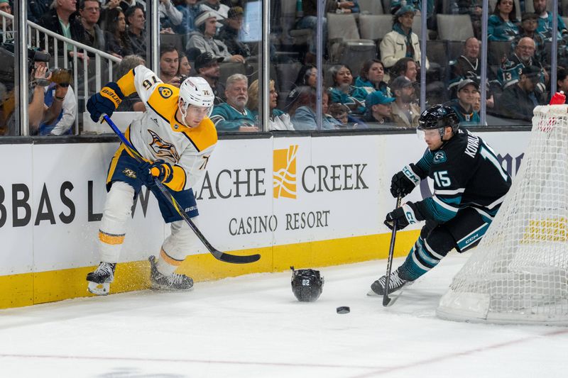 Jan 23, 2025; San Jose, California, USA;  Nashville Predators defenseman Brady Skjei (76) passes the puck from behind the net against San Jose Sharks right wing Nikolai Kovalenko (15) during the second period at SAP Center at San Jose. Mandatory Credit: Neville E. Guard-Imagn Images