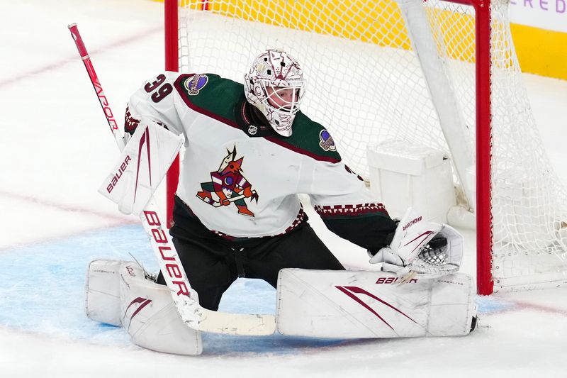 Nov 25, 2023; Las Vegas, Nevada, USA; Arizona Coyotes goaltender Connor Ingram (39) makes a glove save against the Vegas Golden Knights during the third period at T-Mobile Arena. Mandatory Credit: Stephen R. Sylvanie-USA TODAY Sports