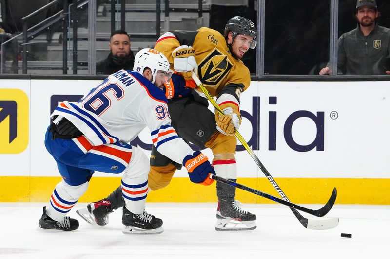 May 6, 2025; Las Vegas, Nevada, USA; Vegas Golden Knights center Brett Howden (21) shoots against the stick of Edmonton Oilers defenseman Jake Walman (96) during the second period of game one of the second round of the 2025 Stanley Cup Playoffs at T-Mobile Arena. Mandatory Credit: Stephen R. Sylvanie-Imagn Images